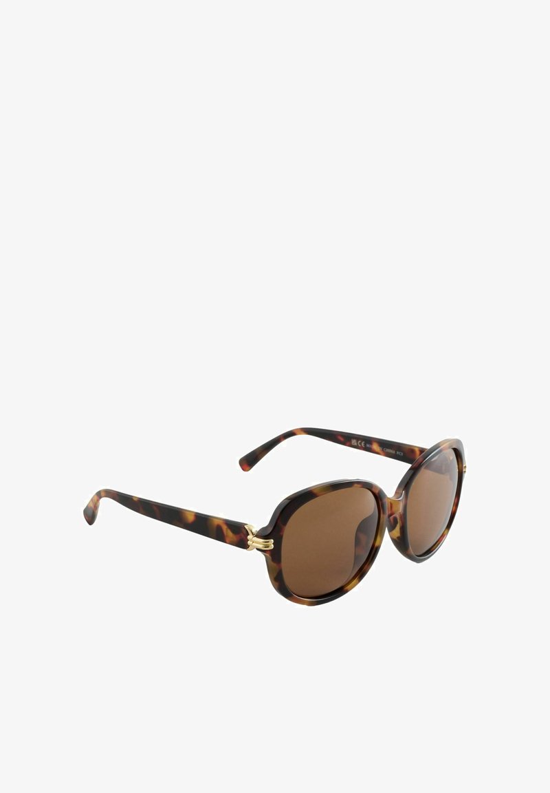 Brūnganā bruņurupuča krāsas saulesbrilles ar apaļiem rāmjiem, brūnām lēcām un zelta toņa metāla detaļām aiz ausīm. Spīdīgs pārklājums.