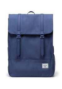 Navy blue backpack with two adjustable straps, top flap, and buckle closures. Features a rectangular shape and a white brand label at the bottom.