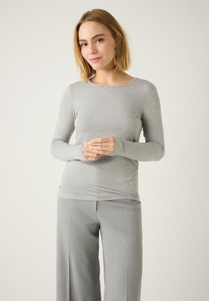 Long-sleeve grey top made of smooth fabric, featuring a round neckline and fitted design, paired with light grey wide-leg trousers.