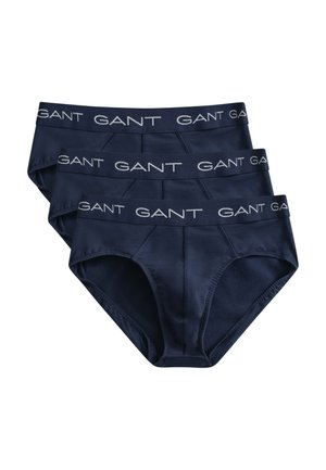 Drei gestapelte marineblaue Herrenslips mit gebrandetem elastischem Bund, beschriftet mit „GANT“ in weißer Schrift.
