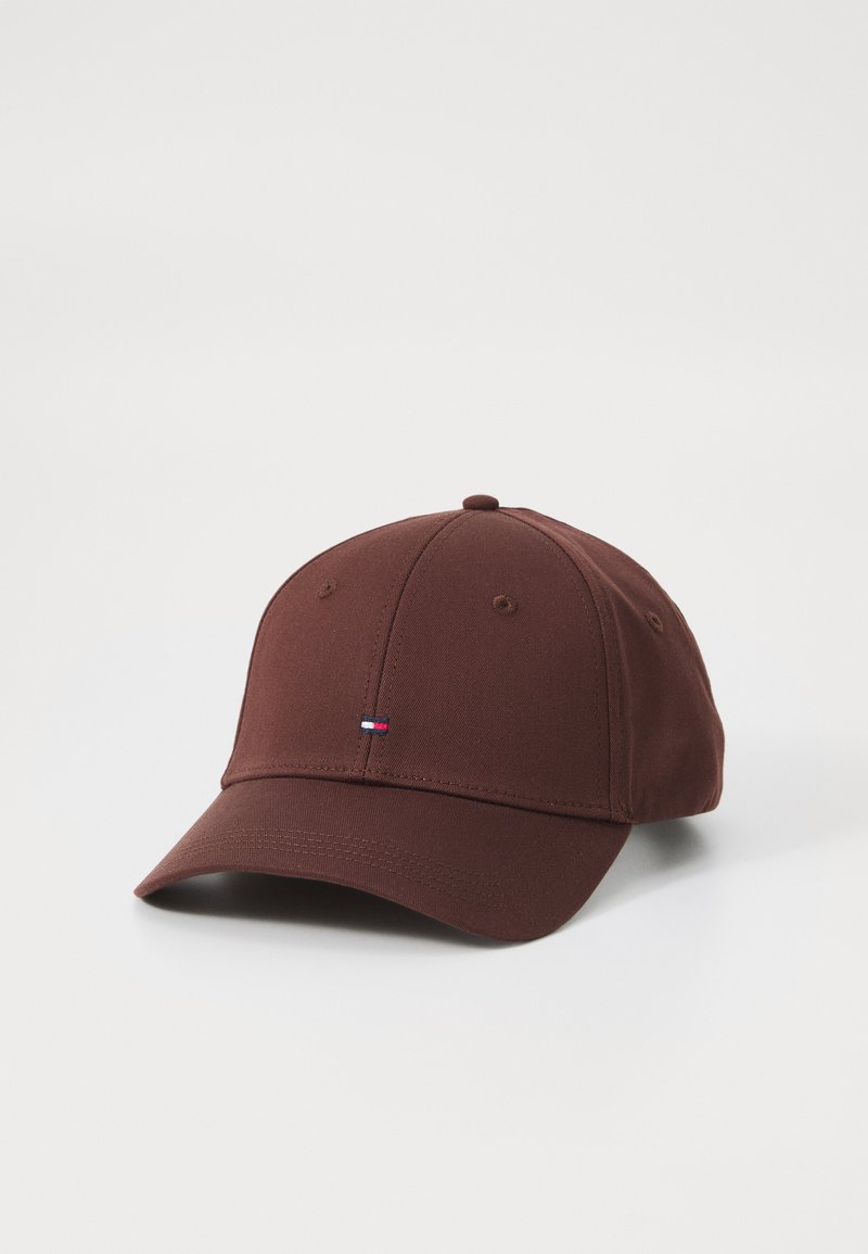 Brown baseball cap made of fabric with a curved brim. Features subtle stitching and a small embroidered logo on the front.