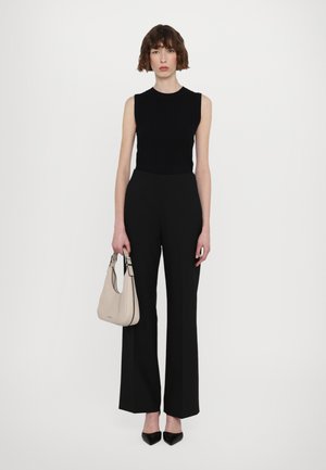 Black ribbed sleeveless top, high-waisted black wide-leg trousers, light beige handbag with silver hardware, and black pointed-toe heels.