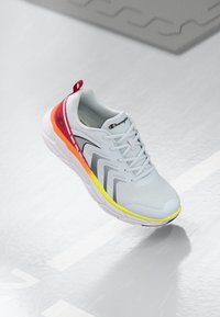 Lightweight grey athletic shoe with a mesh upper, red and yellow accents, and black detailing. Features a textured sole and cushioning.