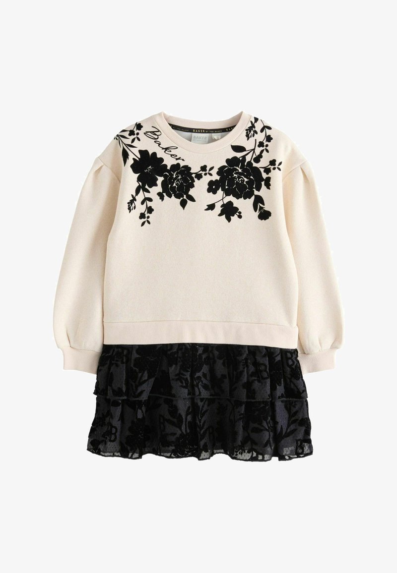 Langärmliges cremefarbenes Sweatshirt mit schwarzem Blumendruck und Puffärmeln, kombiniert mit einem schwarzen, gerafften Rock aus transparenter Stoff.