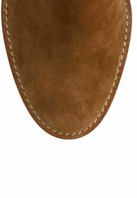 Brown suede shoe upper, rounded toe, with visible stitching along the edge. Smooth texture with a slightly matte finish.