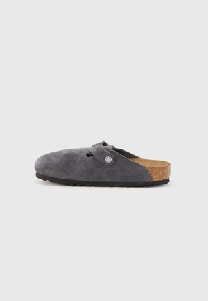 Gray suede slip-on clog with adjustable strap, cork footbed, and black rubber sole, shown from the side on a white background.