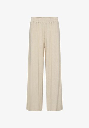 Bēšas platām kājām bikses, izgatavotas no ribota auduma, ar elastīgu jostu un brīvu piegriezumu.