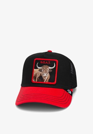 Black trucker cap with red brim; features an embroidered cow graphic and "G.O.A.T." text in red box. Mesh back for ventilation.