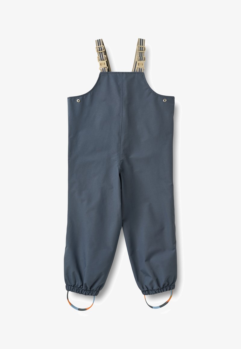 Salopette imperméable bleu foncé avec bretelles rayées réglables, poignets élastiques aux chevilles et accents colorés en boucle sur les jambes. Texture lisse.