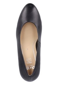 Black leather flat shoe with a rounded toe and smooth upper. Features a cushioned insole and subtle branding on the inside.