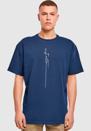 Navy blue cotton t-shirt with a relaxed fit, featuring a white script logo "Faith" printed vertically on the front. Short sleeves.