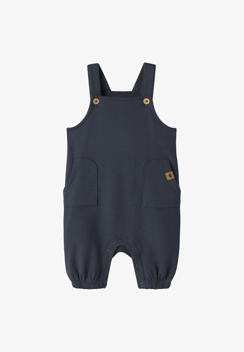 Barboteuse bébé bleu marine sans manches avec bretelles ajustables, poches avant et boutons-pression à l'entrejambe et aux poignets des chevilles.