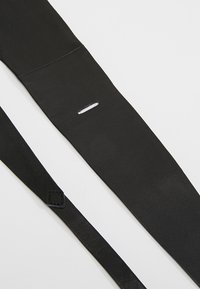 Black leather strap with a smooth texture, featuring a rectangular cutout and stitching details; includes a smaller, attached tab.