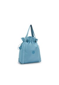 Borsa in nylon azzurro chiaro con apertura a cordoncino, due manici e logo centrale. Texture liscia, forma casual e design minimalista.