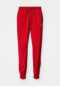 Pantalon de survêtement rouge avec une taille élastique et un cordon de serrage. Chevilles resserrées avec un petit logo sur le côté. Tissu doux et lisse.