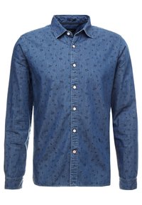 Camisa de denim en azul oscuro con mangas largas, cuello abotonado y un sutil patrón floral. Presenta botones blancos y un acabado texturizado.