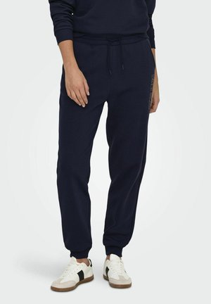 Marineblaue Sweatpants mit einem Kordelzugbund, gerippten Säumen, Seitentaschen und einem Logo-Detail am linken Bein. Aus einem Baumwoll-Mix, lockere Passform.