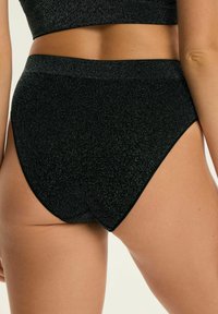 Schwarze glitzernde High-Waist-Unterwäsche mit einer glatten Textur und geschwungenen Beinöffnungen, mit einem kontrastierenden dunklen Bund.
