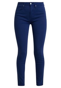 Jeans skinny de color azul marino hechos de una mezcla de algodón elástico, con una cintura alta, cinco bolsillos y un acento de botón plateado en la parte frontal.