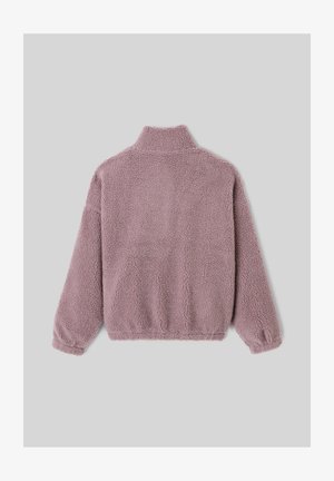 Veste en polaire rose clair, douce et pelucheuse, avec un col montant, des poignets élastiques et un ourlet élastique, présentant une surface texturée et douce.