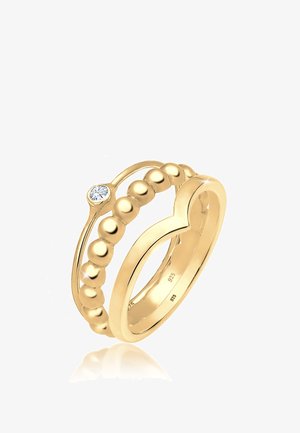 Ensemble de bagues dorées comprenant un design circulaire avec une bande lisse, des perles décoratives et un cristal incrusté unique. Marqué 925 pour la teneur en argent.