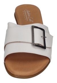 White leather slide sandal with a wide strap featuring a silver buckle. Soft brown insole and a rounded rubber outsole.