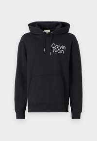 Black hoodie made of soft fabric, featuring a kangaroo pocket, drawstring hood, and a white "Calvin Klein" logo on the left side.