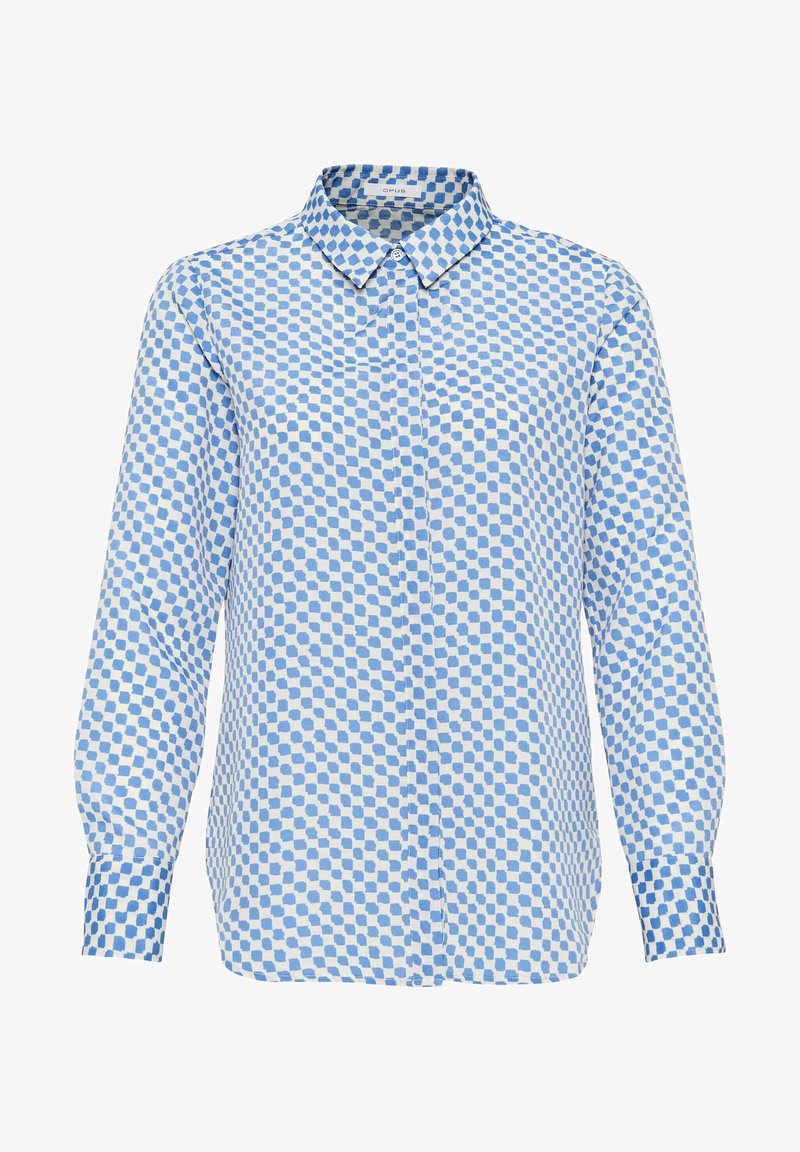 Chemise à manches longues avec col pointu, présentant un motif à carreaux bleu et blanc avec des formes irrégulières.