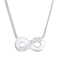 Sølv infinity halskæde med otte klare krystaller langs midten, med en delikat kæde og glat, blank finish.