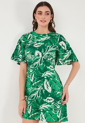 Green leafy print dress with short, wide sleeves and a round neckline; cotton blend material; hemline sits above the knee.