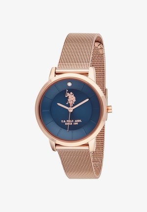 Orologio con cinturino in maglia color oro rosa e quadrante blu navy, con lancette argento, un piccolo diamante decorativo e un emblema con logo al centro.