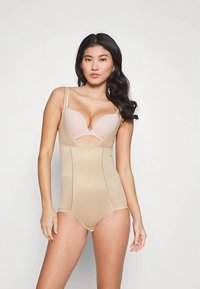 Beige corrigerend lijfje met een gestructureerd ontwerp, gladde stof, verstelbare bandjes en doorschijnende panelen bij de buste.