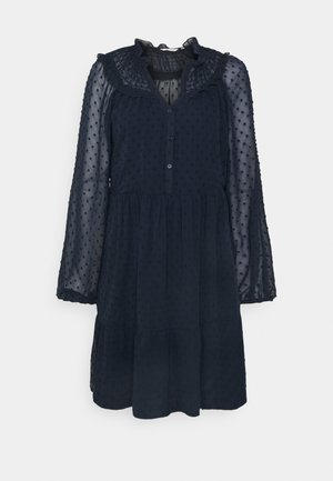 Granatowa, przezroczysta sukienka z długim rękawem, ozdobiona teksturowanymi groszkami, z falbanianym kołnierzem, zapinana na guziki z przodu oraz z warstwowym dołem.