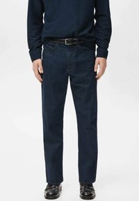 Navy blue denim jeans with a straight fit, five pockets, and a zip fly, paired with a black belt and black shoes. Smooth texture.