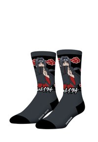 Chaussettes noires avec un graphique d'un personnage aux longs cheveux foncés, vêtu d'un outfit rouge et gris, agrémenté de motifs de nuages rouges et de textes blancs.