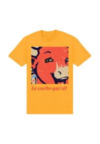 Orange bomull t-shirt med en grafik av en leende ko med ett örhänge, tillsammans med texten "La vache qui rit" i rosa.