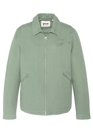 Lysegrøn lynlåstrøje med flad krave, tre lommer med lynlås og "Schott" mærke på brystet og indvendig label.