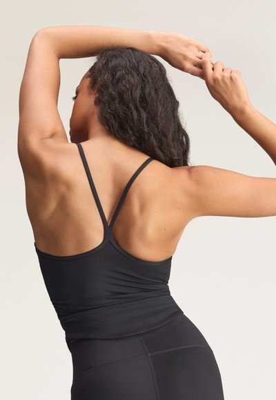 Black sports tank top with thin straps, featuring a fitted design and smooth, stretchy fabric. Back has a racerback cut.