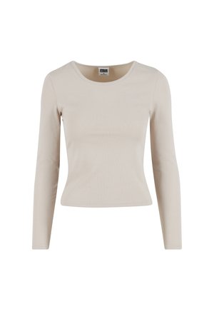 Maglietta a maniche lunghe di colore beige chiaro realizzata in tessuto a costine. Presenta un collo rotondo e una silhouette aderente. Tessuto morbido e senza motivi visibili.