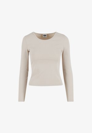 Maglietta a maniche lunghe di colore beige chiaro realizzata in tessuto a costine. Presenta un collo rotondo e una silhouette aderente. Tessuto morbido e senza motivi visibili.