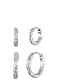 Boucles d'oreilles en argent en forme de créole avec un design texturé et organique. Comprend deux tailles : épaisse et fine, chacune affichant un motif de surface irrégulier.