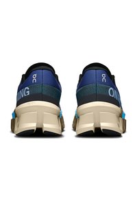 Blue and black running shoes with a textured mesh upper, bold white branding, and a cushioned beige sole featuring multi-directional treads.