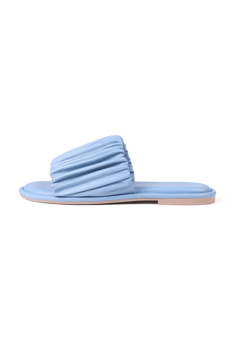 Light blue slide sandal with gathered textured upper, flat sole, and beige accents. Material appears soft and flexible.