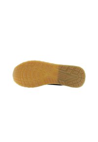 Sole di una scarpa con un design in gomma testurizzata di colore beige, che presenta scanalature e motivi per garantire trazione.