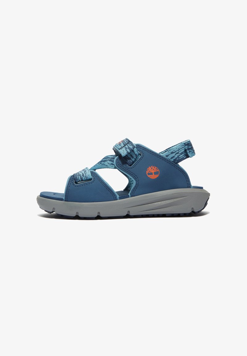 Blue sandals with cross straps and adjustable closures, made of synthetic material. Grey sole with traction pattern. Features logo accent.