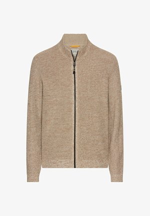 Cardigan en tricot beige avec un col haut, fermeture éclair à l'avant et tissu texturé. Présente une coupe standard et un design minimaliste.