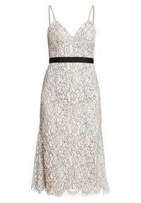 Pitsimekko, jossa on v-aukkoinen kaula-aukko, kermanvärinen pohja ja kukkakuosi. Ominaisuuksia ovat ohuet hihnat ja musta vyötärönauha. Helma on reunustettu aaltoilevalla yksityiskohdalla.