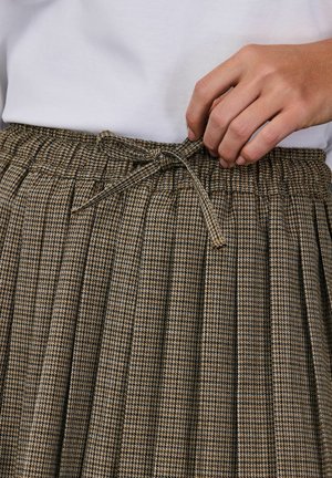 Brown and black houndstooth patterned skirt with pleats and an elastic waistband, featuring a drawstring tie at the waist.