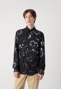 Langärmliges Hemd aus schwarzem Stoff mit floralem Muster in Dunkelblau und Weiß. Verfügt über eine Knopfleiste vorne und ein klassisches Kragen Design.