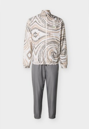 Tracksuit with beige, white, and gray abstract swirl patterned zip-up jacket and solid gray elastic cuffed pants.